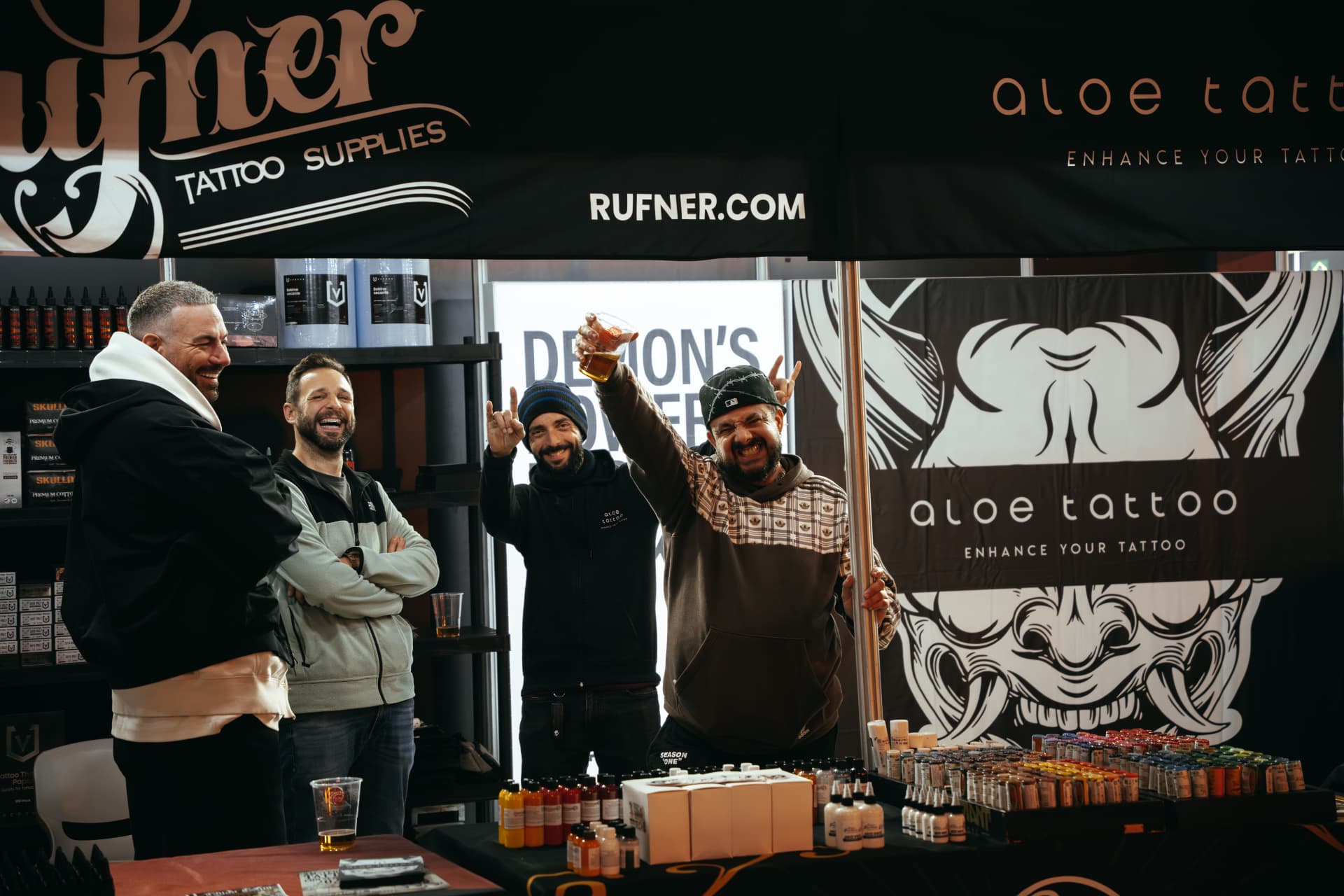 Exhibitors celebrating at a supplies stand